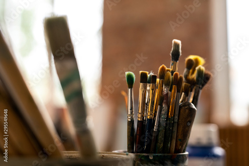 Group of various paintbrushes for professional painting on workplace of artist