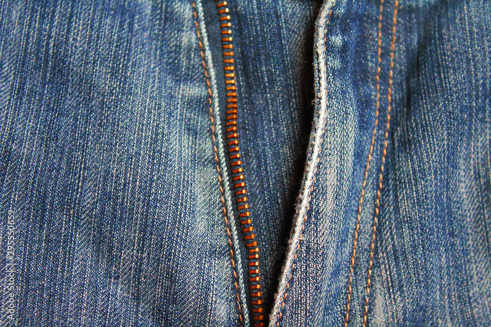 Zipper lock on old jeans. Close-up. Vertical view. Background. Texture. Zipper lock on old jeans. Close-up. Vertical view. Background. Texture.