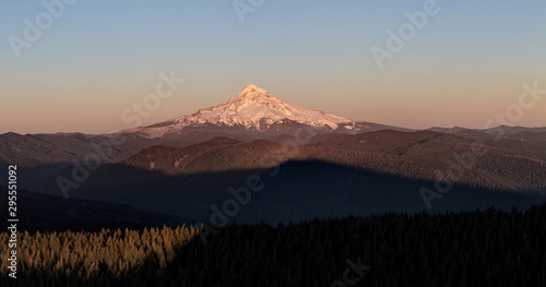 Mount Hood Covered in Snow, active stratovolcano and highest mountain in Oregon. Panoramic View from Sherrard Point, Fire Lookout at the top of Larch Mountain. Sunset, Purple Sky, Glowing Summit