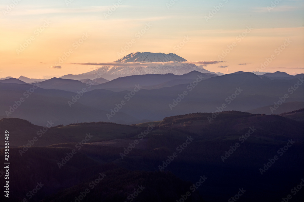 Mount St. Helens, active stratovolcano in Skamania County, Washington. Panoramic View from Sherrard Point, Fire Lookout at the top of Larch Mountain, Oregon. Sunset, Orange Sky, Mountain Silhouette