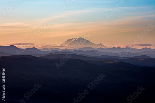 Mount Rainer, active volcano in Washington State, USA. Panoramic View from Sherrard Point, Fire Lookout at the top of Larch Mountain, Oregon. Sunset, Orange Sky, Mountain Silhouette, Layers