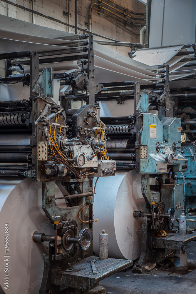 Old Printing press with rolls of paper Old Printing press with rolls of paper