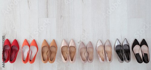 Collection of elegant shoes on floor, flat lay with space for text
