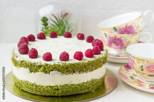 Delicious birthday cake with spinach and raspberries.