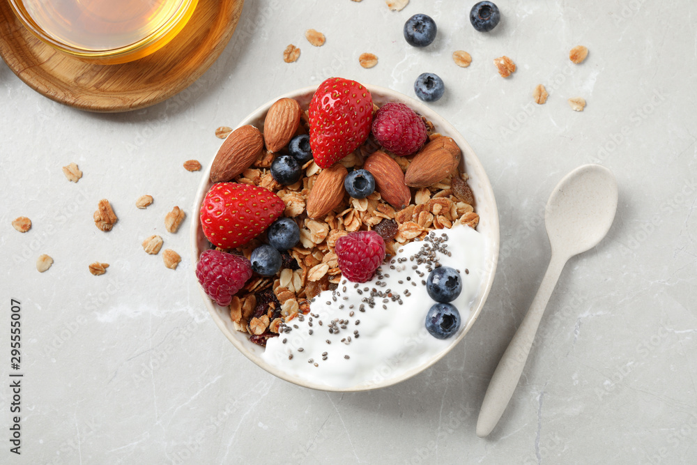 Tasty homemade granola served on marble table, flat lay. Healthy breakfast Tasty homemade granola served on marble table, flat lay. Healthy breakfast