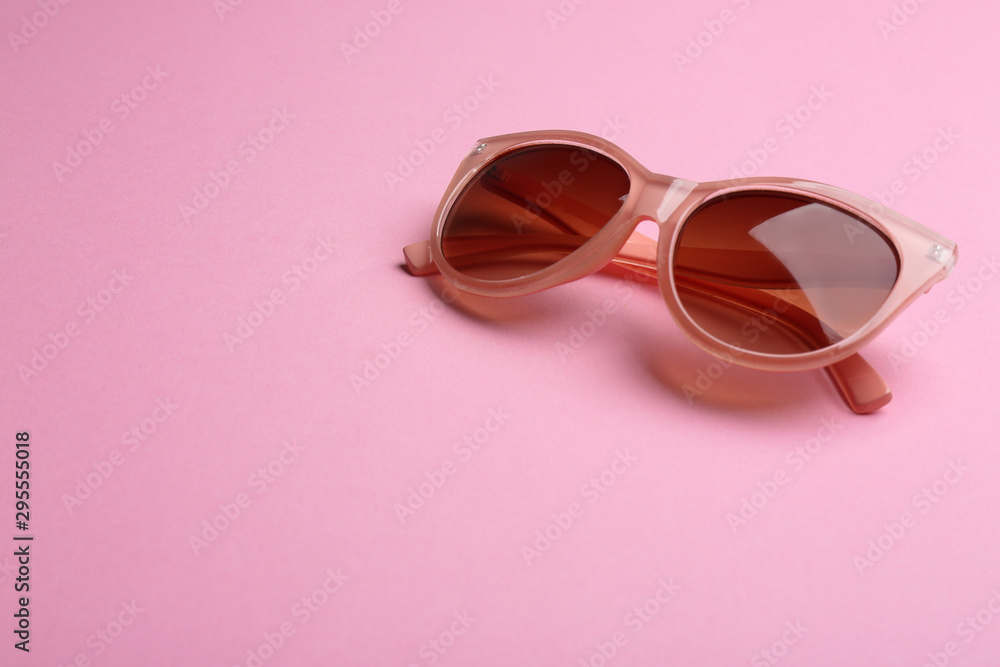 Stylish sunglasses on pink background, space for text. Fashionable accessory Stylish sunglasses on pink background, space for text. Fashionable accessory