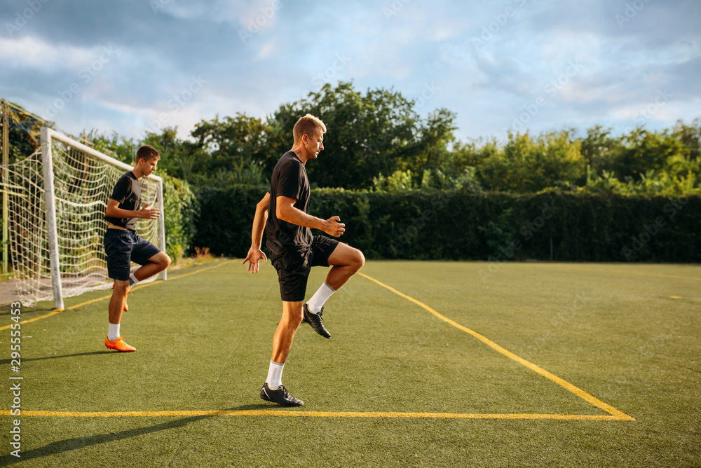Obraz premium Two male soccer players training on the field