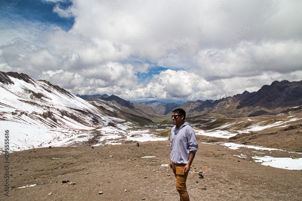 Man with panoramic view. Hiking scene in Vinicunca, Cusco region, Peru. Montana of Seven Colors, Rainbow Mountain. Man with panoramic view. Hiking scene in Vinicunca, Cusco region, Peru. Montana of Seven Colors, Rainbow Mountain.