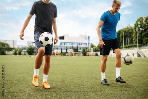 Male soccer players stuffs ball with their feet