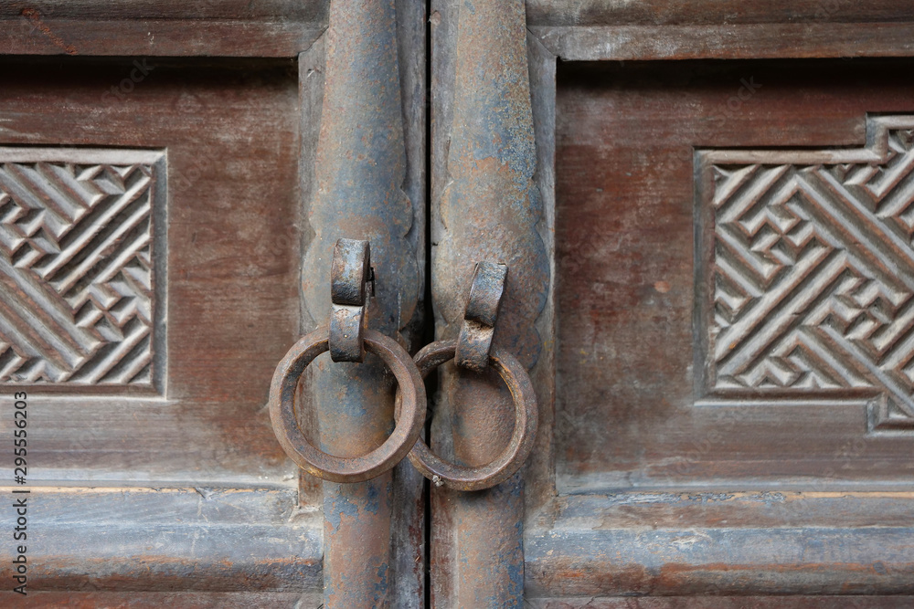 Traditional Chinese Residences interior wooden door and metal door ring in Tianshui Folk Arts Museum Hu Shi folk house, Gansu China Traditional Chinese Residences interior wooden door and metal door ring in Tianshui Folk Arts Museum Hu Shi folk house, Gansu China