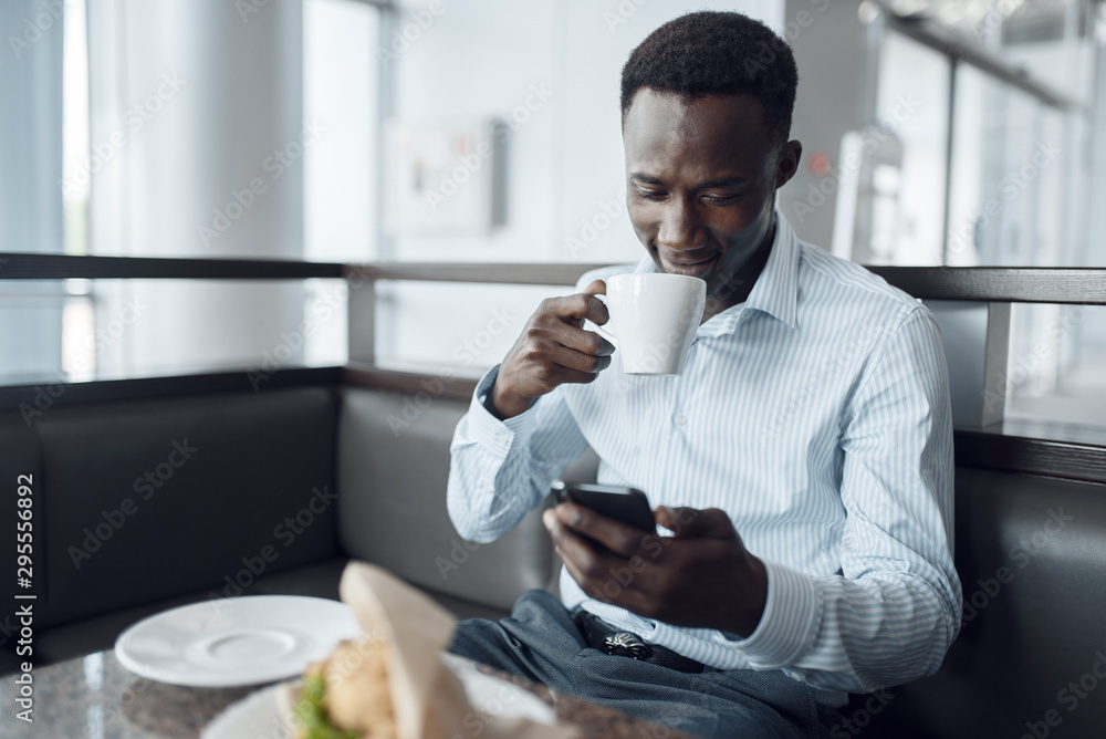 Ebony businessman having lunch in office cafe Ebony businessman having lunch in office cafe