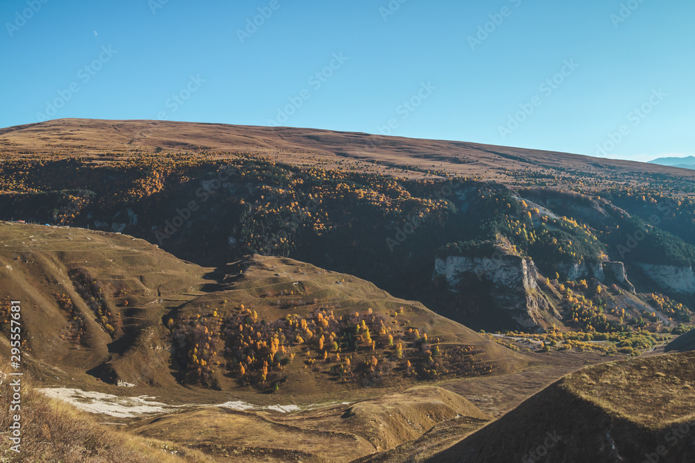 Golden autumn day in the mountains of Chechnya. Mountainous landscape. Outskirts of Khoy village and Kazenoyam lake. Russia, North Caucasus.