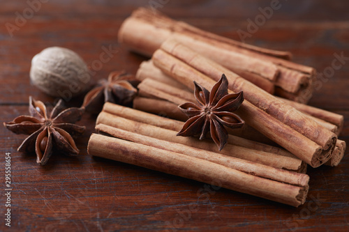 Star anise with cinnamon. Christmas spices on rustic wooden background. Close up. 