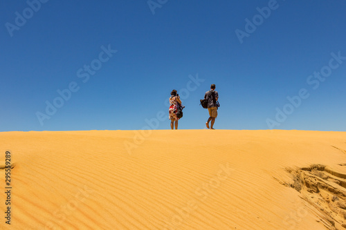 A man and a woman at the desert horizon.