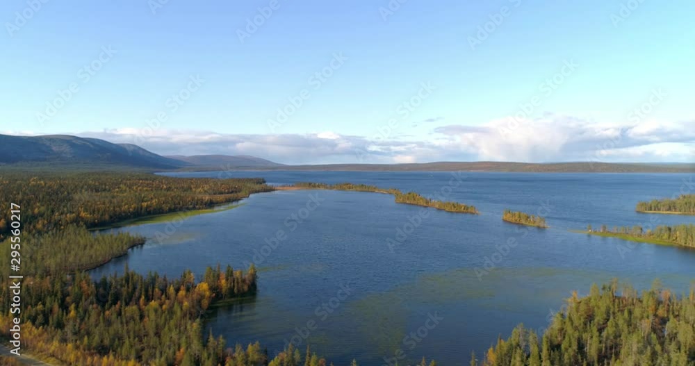 Pallasjarvi, Aerial, reverse, drone shot, of islands on a lake, surrounded by autumn color forest, ounastunturit in the background, on a sunny, fall day, in Pallas-Yllas national park, Muonio, Finland Pallasjarvi, Aerial, reverse, drone shot, of islands on a lake, surrounded by autumn color forest, ounastunturit in the background, on a sunny, fall day, in Pallas-Yllas national park, Muonio, Finland