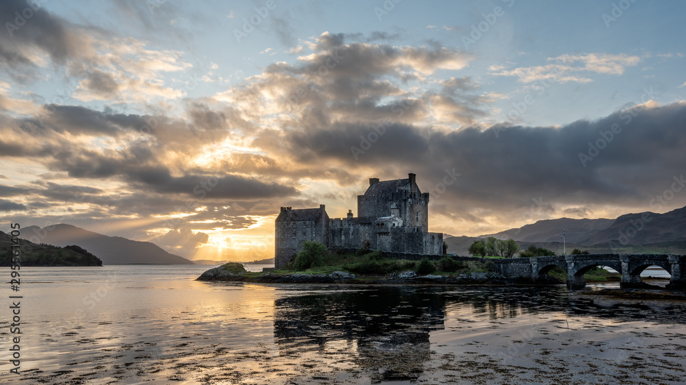 Eilean Donan Castle, Scotland with dramatic sunset sky in background