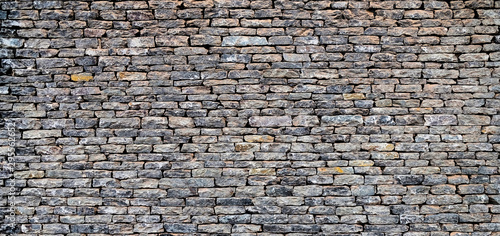 Perfect dry stone wall panoramic background. photo