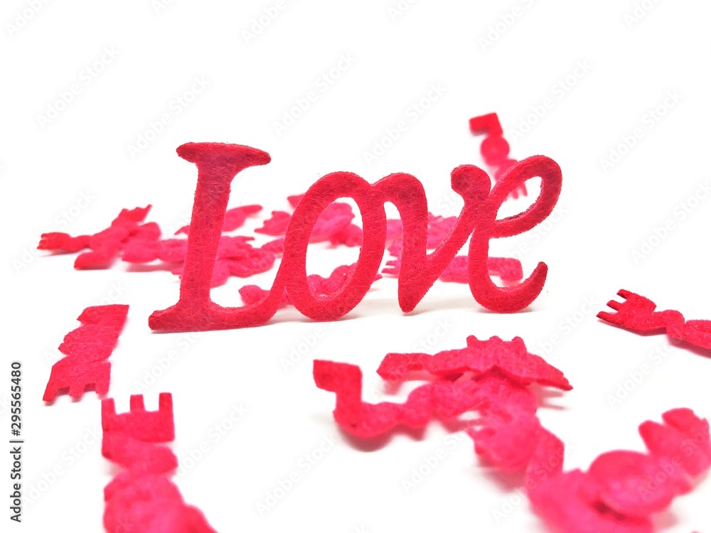 The letters are made of red, green sponge. The word love on a white background. The letters are made of red, green sponge. The word love on a white background.