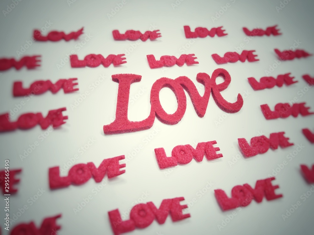 The letters are made of red, green sponge. The word love on a white background. The letters are made of red, green sponge. The word love on a white background.