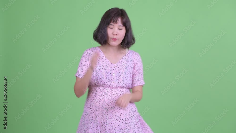 Happy Asian pregnant woman dancing Happy Asian pregnant woman dancing