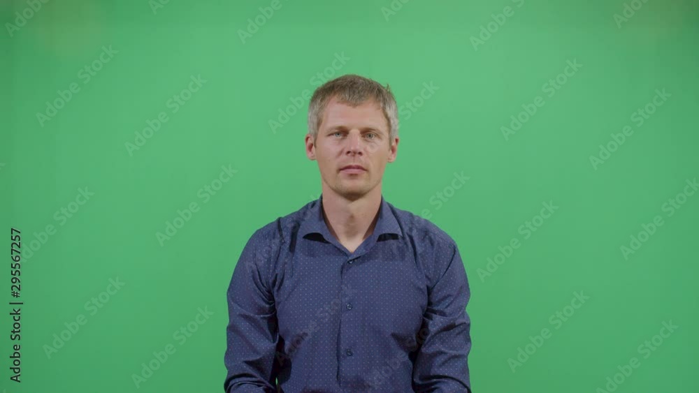 Aggressive Adult Man Executing The Viewer With The Hand In Shape Of A Gun. Studio Isolated Shot Against Green Screen Background Aggressive Adult Man Executing The Viewer With The Hand In Shape Of A Gun. Studio Isolated Shot Against Green Screen Background