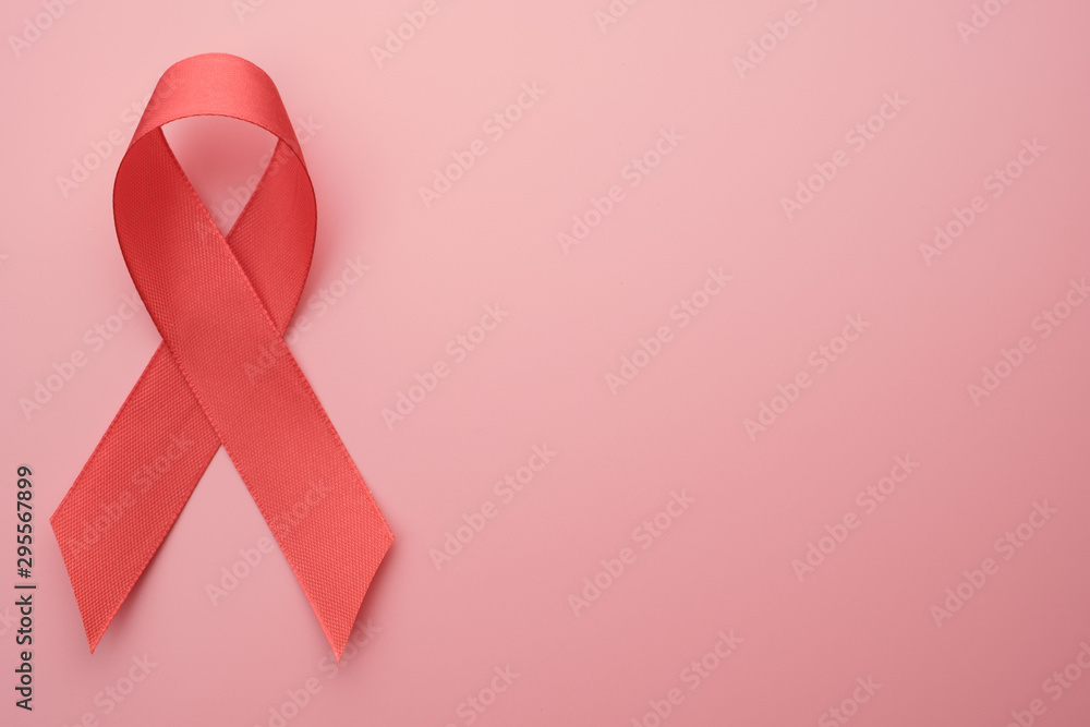 Red ribbon on pink background with copy space, banner concept. Red ribbon on pink background with copy space, banner concept.