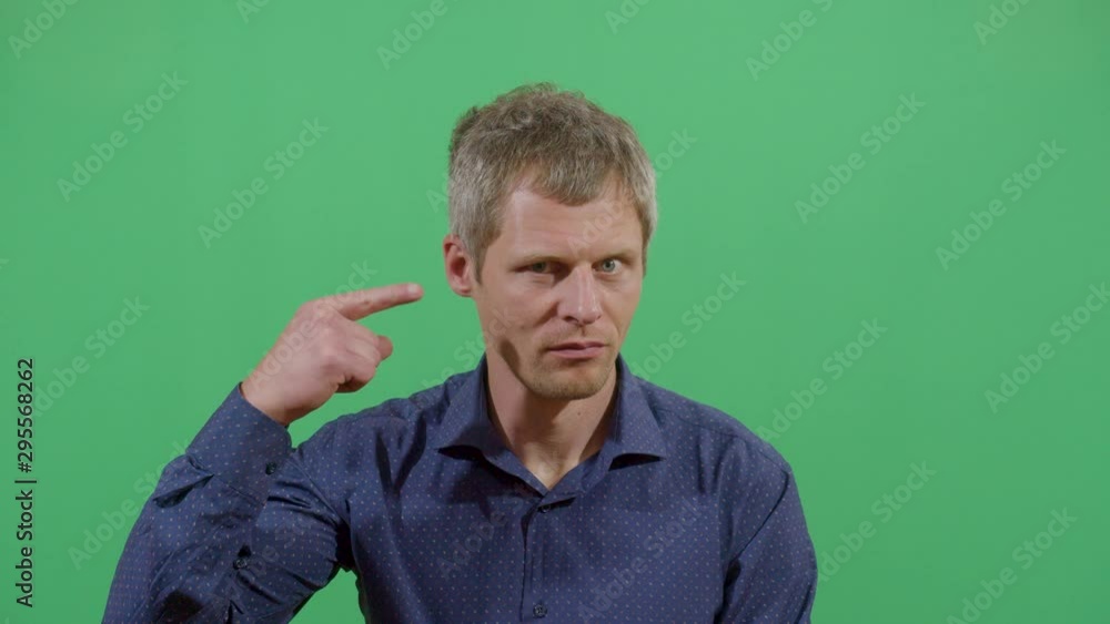 Adult Man Telling The Viewer That Something Crazy Is Going On. Studio Isolated Shot Against Green Screen Background Adult Man Telling The Viewer That Something Crazy Is Going On. Studio Isolated Shot Against Green Screen Background