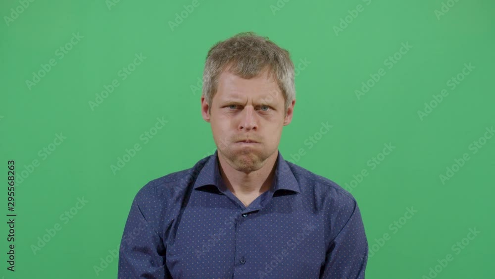 Adult Man Inflating The Cheeks. Studio Isolated Shot Against Green Screen Background Adult Man Inflating The Cheeks. Studio Isolated Shot Against Green Screen Background