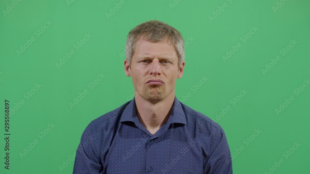Facial Expression Of A Adult Man Pouting. Studio Isolated Shot Against Green Screen Background Facial Expression Of A Adult Man Pouting. Studio Isolated Shot Against Green Screen Background