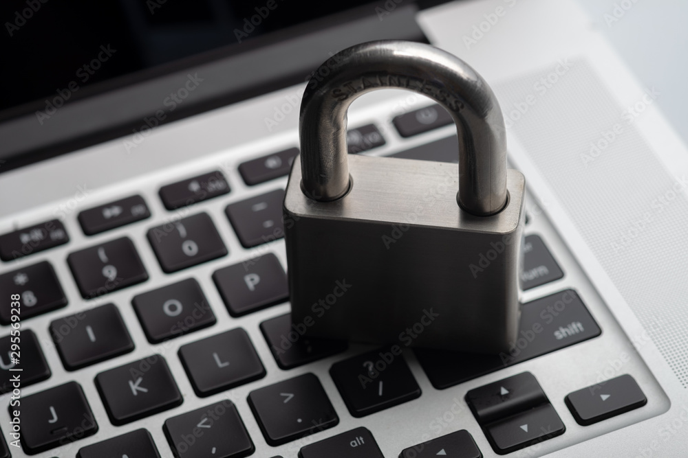 Stainless steel padlock on laptop keyboard, computer protection concept. Stainless steel padlock on laptop keyboard, computer protection concept.