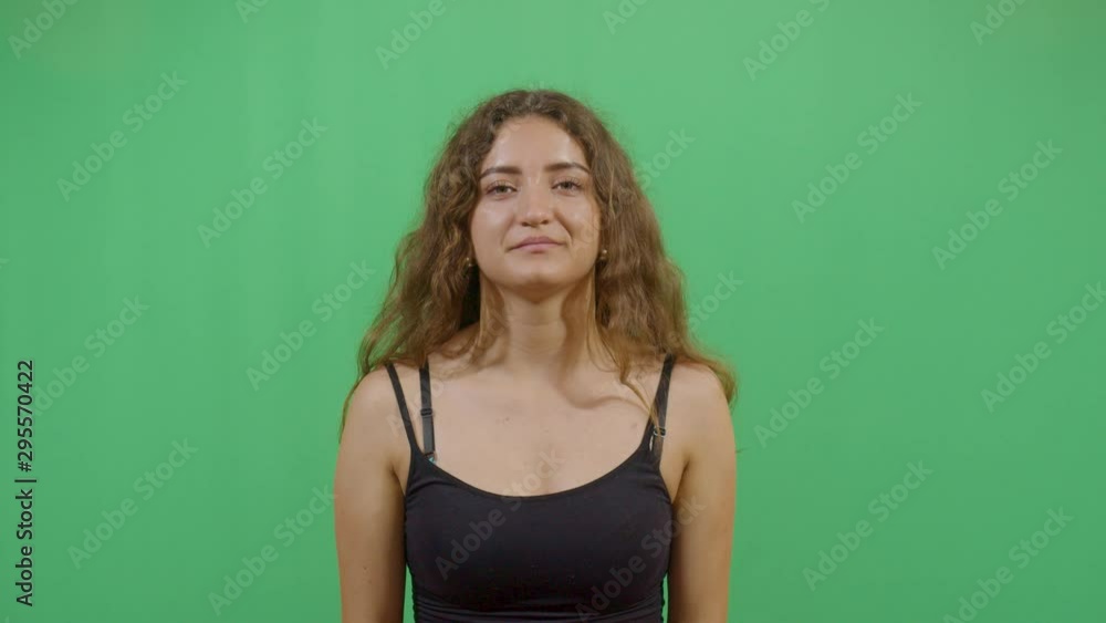 Aggressive Woman Executing The Viewer With The Hand In Shape Of A Gun. Studio Isolated Shot Against Green Screen Background Aggressive Woman Executing The Viewer With The Hand In Shape Of A Gun. Studio Isolated Shot Against Green Screen Background