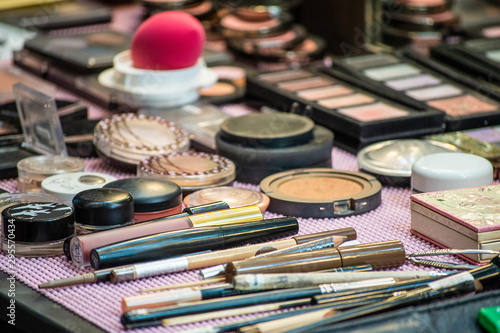A professional makeup artist's work table with various cosmetics on it.