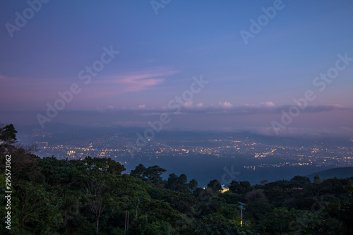 Blue and pink rainy night sky over San Salvador and Santa Tecla, El Salvador, Central America. September 2019