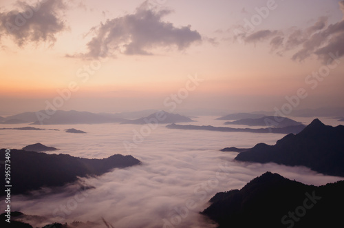 sunrise with dark mountain and mist