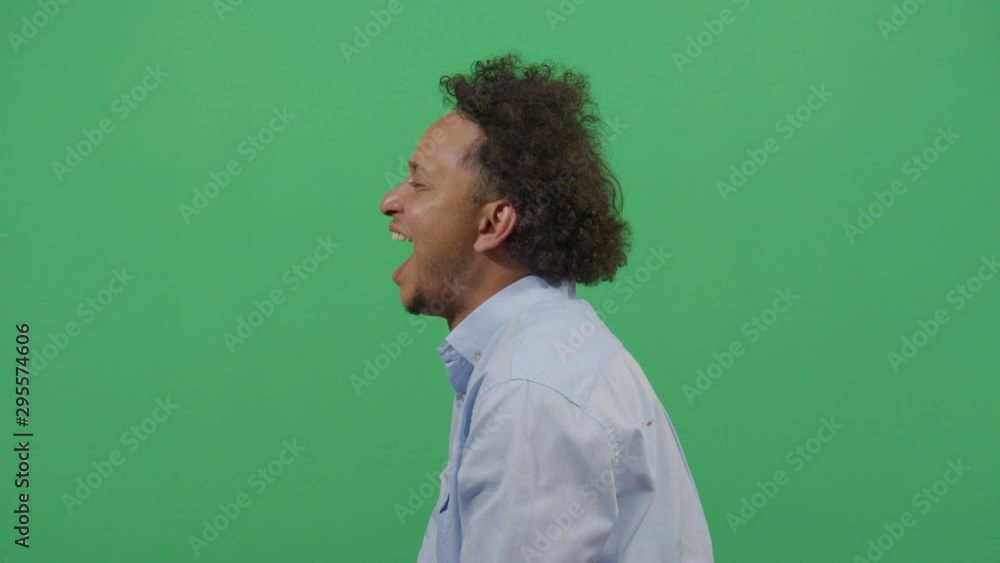 Adult Man Lateral Shot Screaming Hard In A Deep State Of Frenzy. Studio Isolated Shot Against Green Screen Background Adult Man Lateral Shot Screaming Hard In A Deep State Of Frenzy. Studio Isolated Shot Against Green Screen Background
