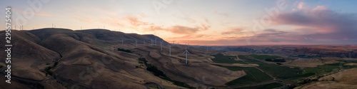 Beautiful Aerial Panoramic Landscape View of Wind Turbines on a Windy Hill during a colorful sunrise. Taken in Washington State, United States of America.