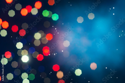 Defocused of beautiful  polygon lights and light ray..Bokeh of colorful lighting in 7 polygon heptagon in smoky night background with copyspace. photo