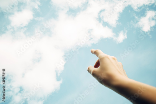 Finger points to the sky. Concept of cloud storage or cloud gaming