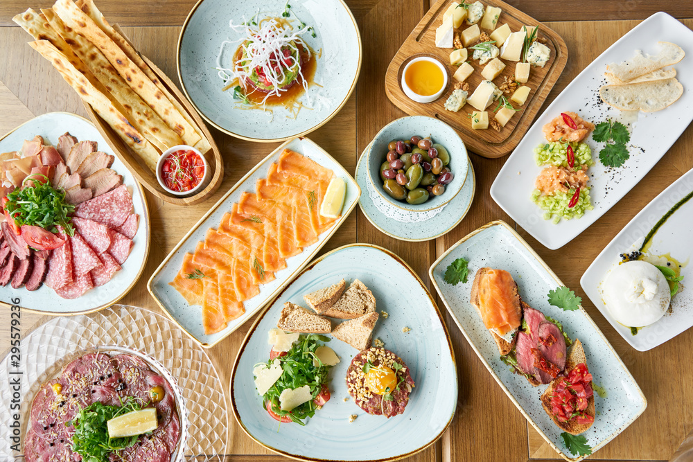 Variety of dishes on the table. Various snacks and antipasti on the table. Restaurant menu. Italian cuisine Variety of dishes on the table. Various snacks and antipasti on the table. Restaurant menu. Italian cuisine