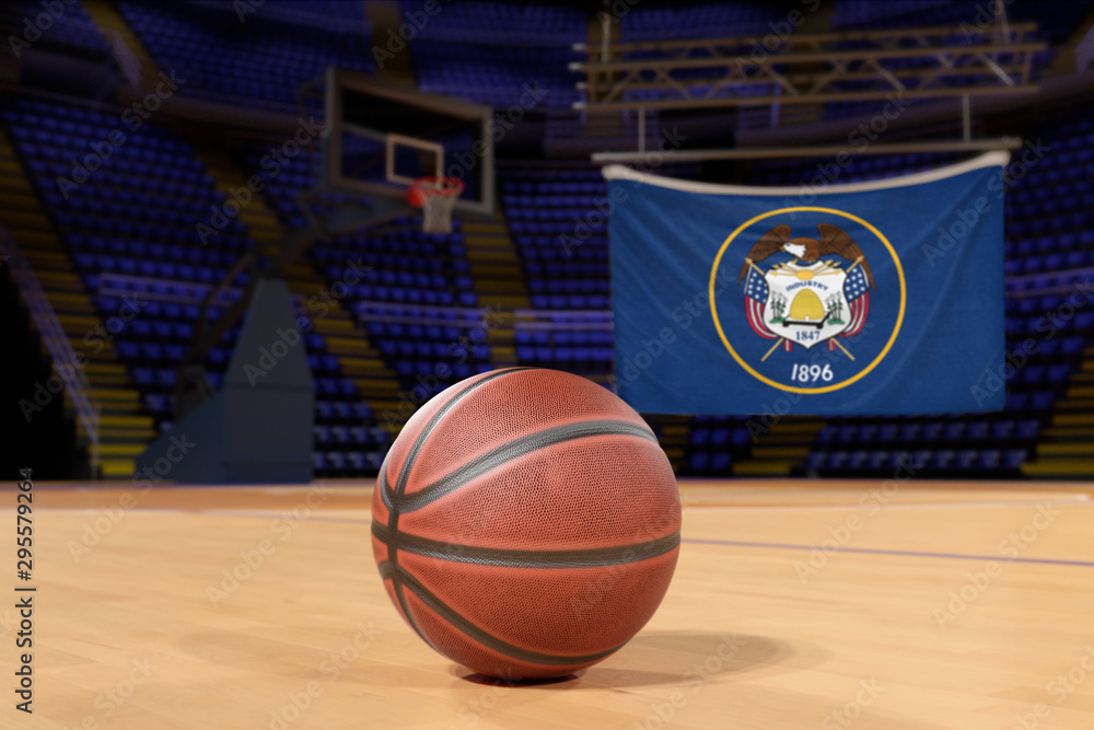 Naklejka premium Utah state flag and basketball on Court Floor