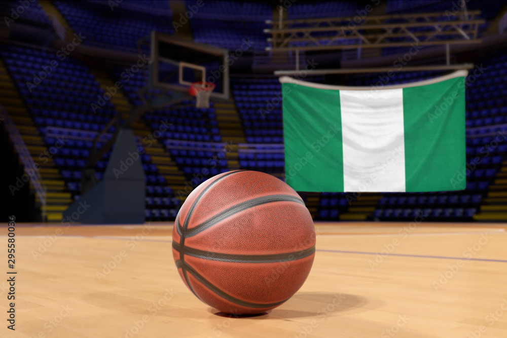 Naklejka premium Nigeria flag and basketball on Court Floor