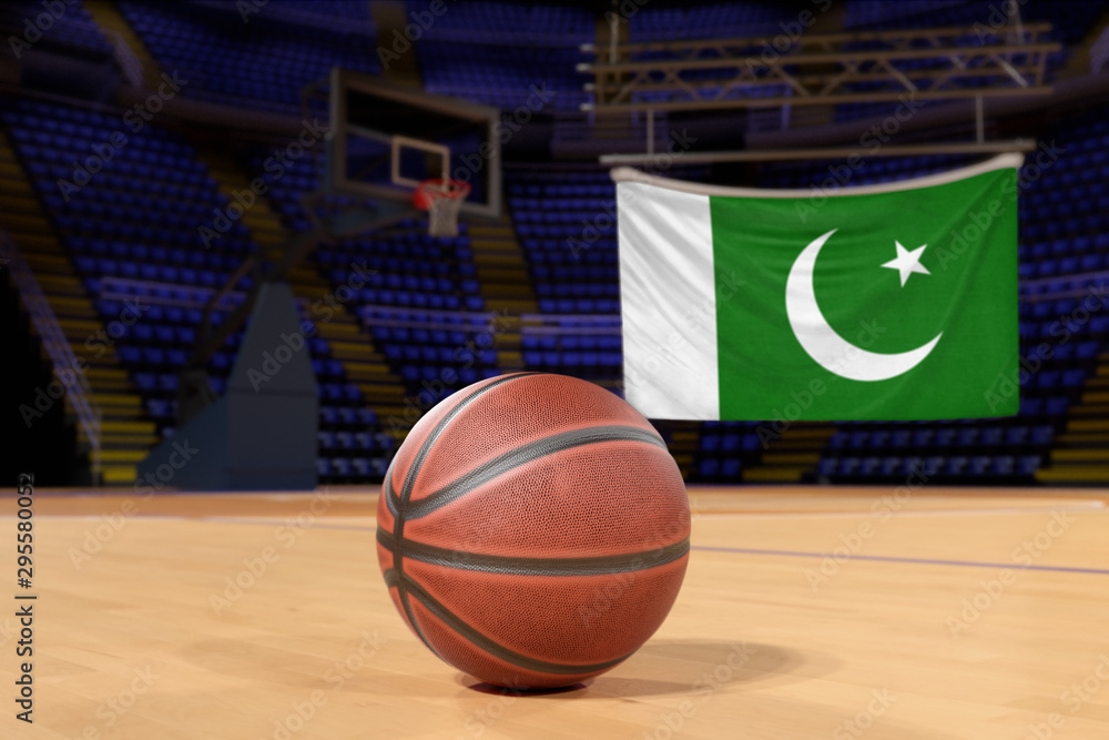 Naklejka premium Pakistan flag and basketball on Court Floor