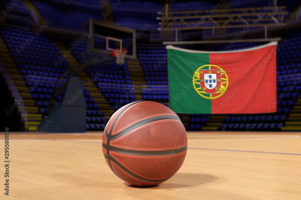Naklejka premium Portugal flag and basketball on Court Floor