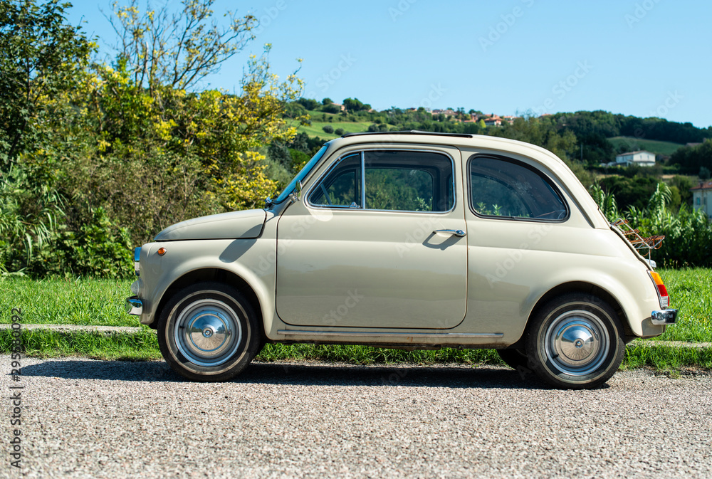 Vintage beige color car. Small old car. Italian car.
