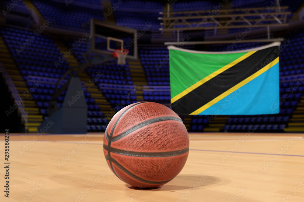 Naklejka premium Tanzania flag and basketball on Court Floor