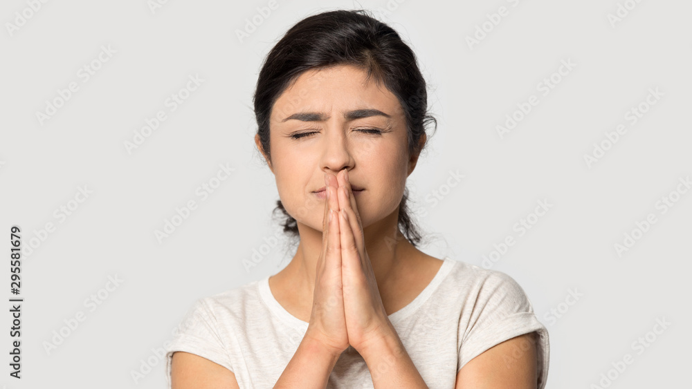 Indian girl believer with prayer hands make wish