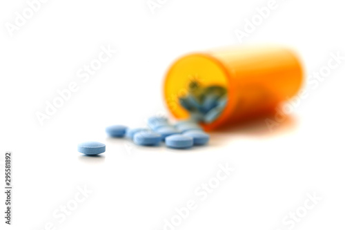 Tablets scattered blue color jar on the table of pharmaceutical laboratory pill for the prescription and treatment various diseases chemistry
