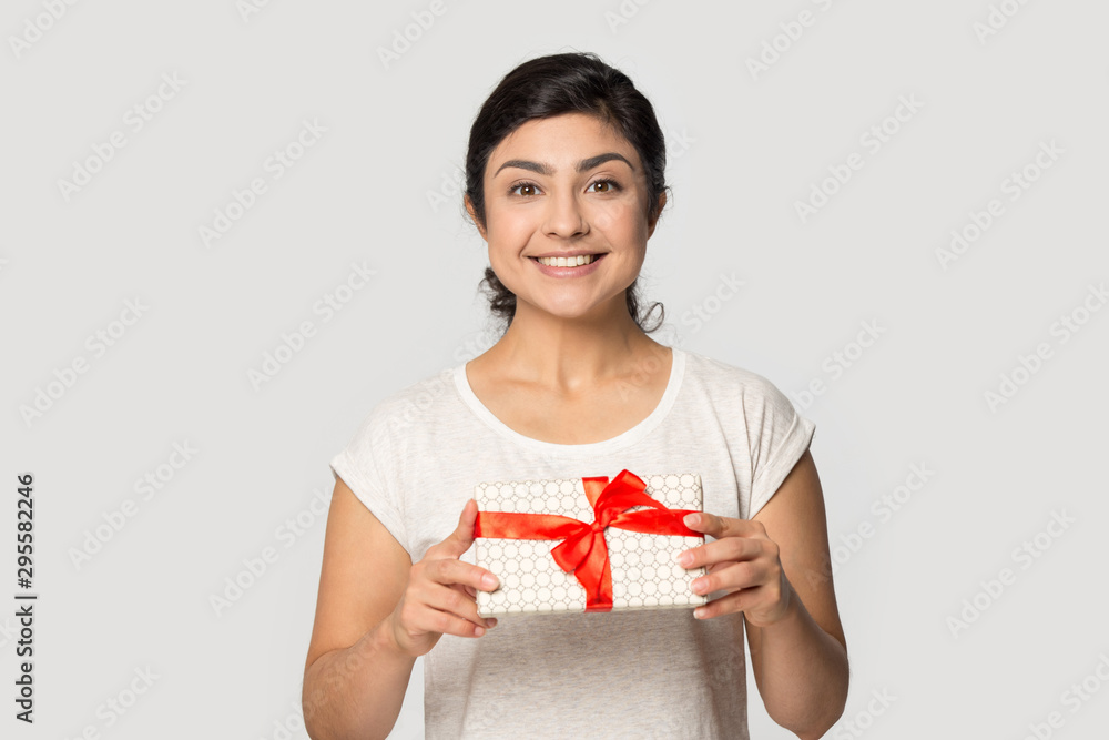 Smiling indian girl make birthday present give gift box Smiling indian girl make birthday present give gift box