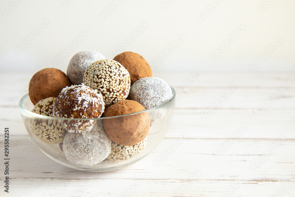 Energy balls in a glass bowl on a white background Energy balls in a glass bowl on a white background