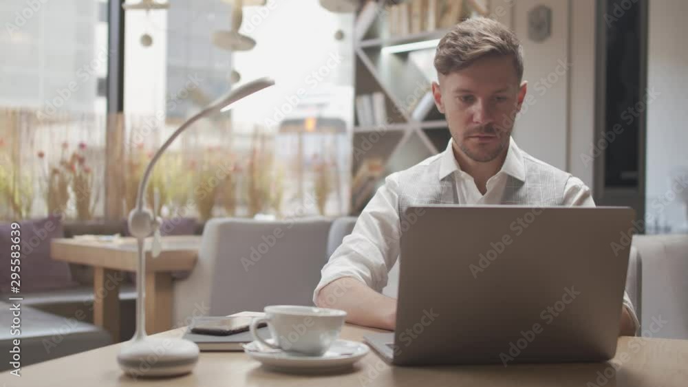 Businessman sitting and working in a cafe. Man using computer devices. Business and entrepreneurship. Businessman sitting and working in a cafe. Man using computer devices. Business and entrepreneurship.
